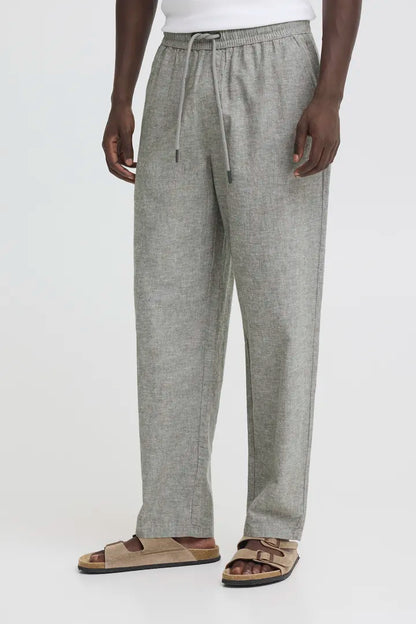 Men's relaxed Trousers Blend Aban Linen Trousers Dusty Olive Relaxed Wear Colour: Dusty Olive Material: 70% Cotton & 30% Linen Person wearing gray pants with a white background
