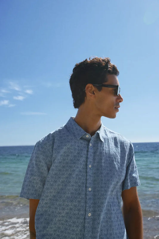 Mens Blend Aban Short Sleeved Shirt Lichen Blue Smart Shirt by Blend. Colour: Lichen Blue Material: 100% Cotton Man wearing sunglasses and a blue patterned shirt standing on a beach.