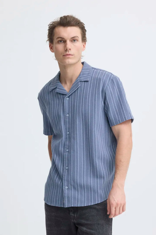 Blend Dimy Slub Short Sleeved Shirt Salute men's by Blend. Colour: Faded Denim Material: 80% Polyester & 20% Cotton Man wearing a blue striped shirt against a white background