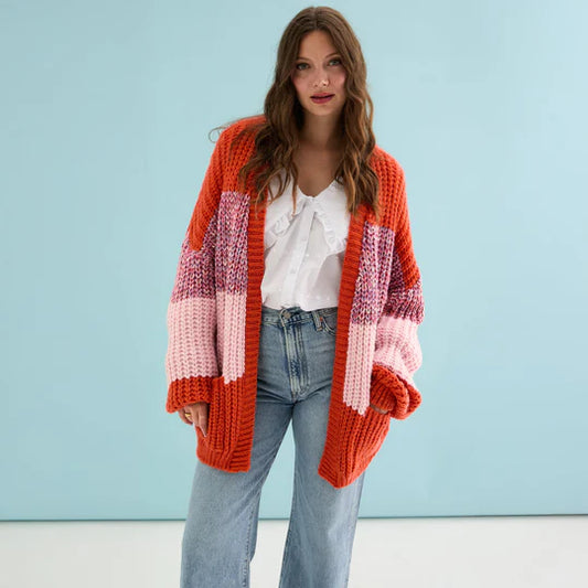 Cara & The Sky Janie Oversized Chunky Stripe Cardigan Orange Womens Cardigan oversized Woman wearing a colorful striped cardigan against a light blue background