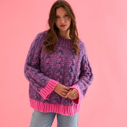 Cara & The Sky Jennie Cable High Neck Balloon Sleeve Jumper Womens Jumper warm baggy jumper Woman wearing a purple and pink sweater against a pink background