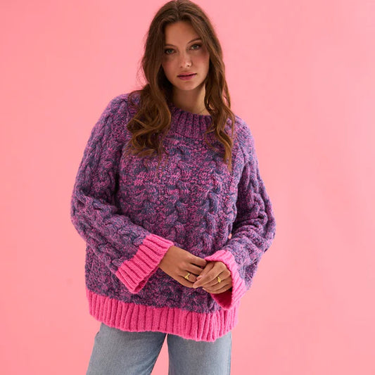 Cara & The Sky Jennie Cable High Neck Balloon Sleeve Jumper Womens Jumper warm baggy jumper Woman wearing a purple and pink sweater against a pink background