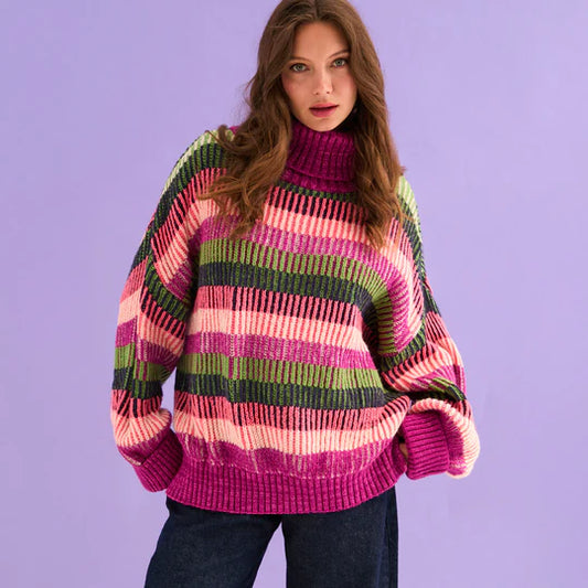Cara & The Sky Tasha Oversized Balloon Sleeve Stripe Roll Neck Jumper Purple Womens Jumper warm baggy jumper Woman wearing a colorful striped sweater against a purple background
