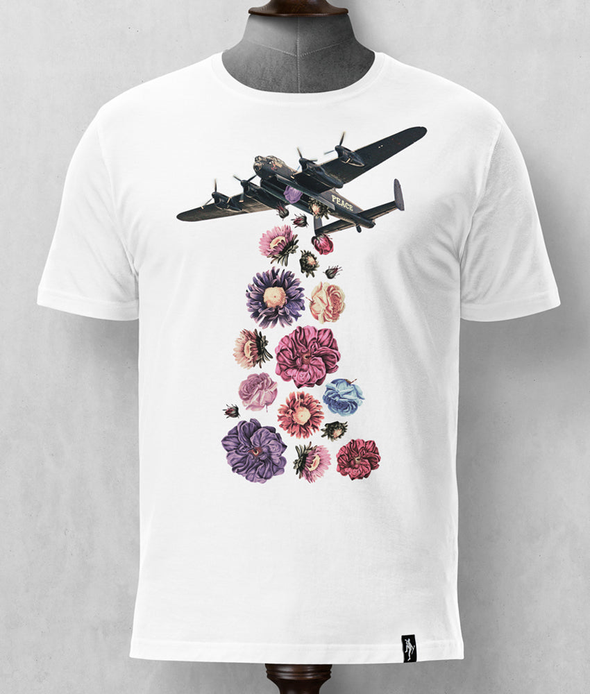 Dirty Velvet Flower Power White T-shirt mens graphic tee. Dirty Velvet designs are exclusively limited to a single print run for each collection. Tailored T-shirts are made from a soft but robust, medium weight, 100% organic cotton. The water-based inks used for our fine detail prints are not only better for the environment but also have a very soft hand feel on the garment. T-shirts are finished with a White t-shirt with a graphic of a bomber plane releasing flowers on a mannequin against a gray background