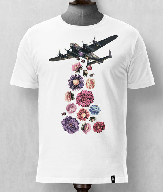 Dirty Velvet Flower Power White T-shirt mens graphic tee. Dirty Velvet designs are exclusively limited to a single print run for each collection. Tailored T-shirts are made from a soft but robust, medium weight, 100% organic cotton. The water-based inks used for our fine detail prints are not only better for the environment but also have a very soft hand feel on the garment. T-shirts are finished with a White t-shirt with a graphic of a bomber plane releasing flowers on a mannequin against a gray background