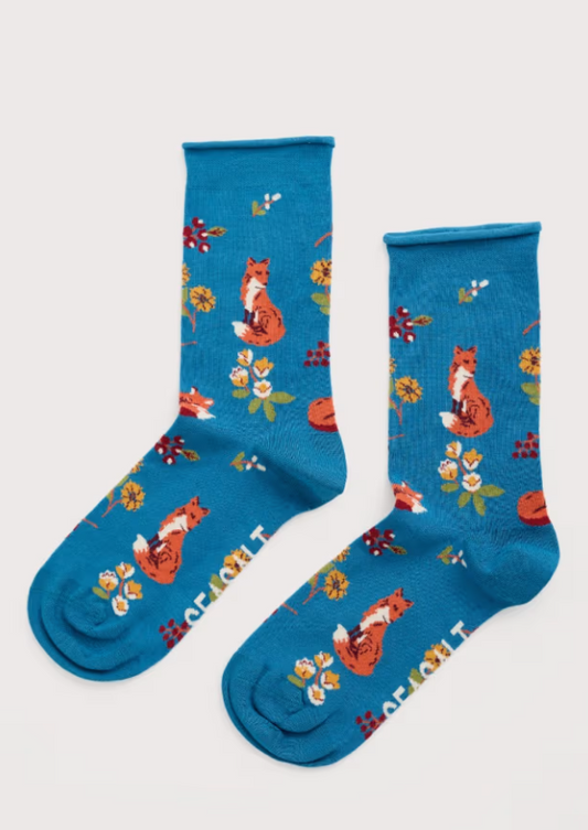Blue socks with fox and floral patterns on a white background 
