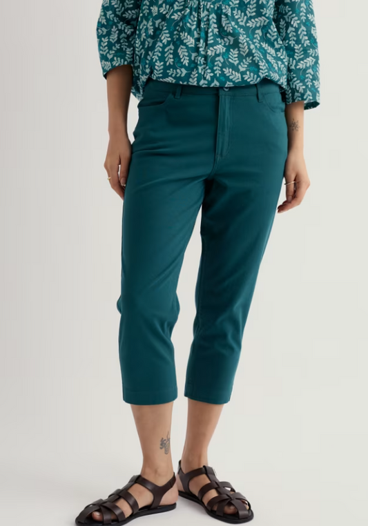 Seasalt Albert Quay Crops Dark Wreckage womens summer trousers Slim leg fit with Zip and button fastening and Front and back pockets Colour: Dark Wreckage Material: 98% Organic Cotton & 2% Elastane Person wearing teal pants and a patterned top on a light gray background