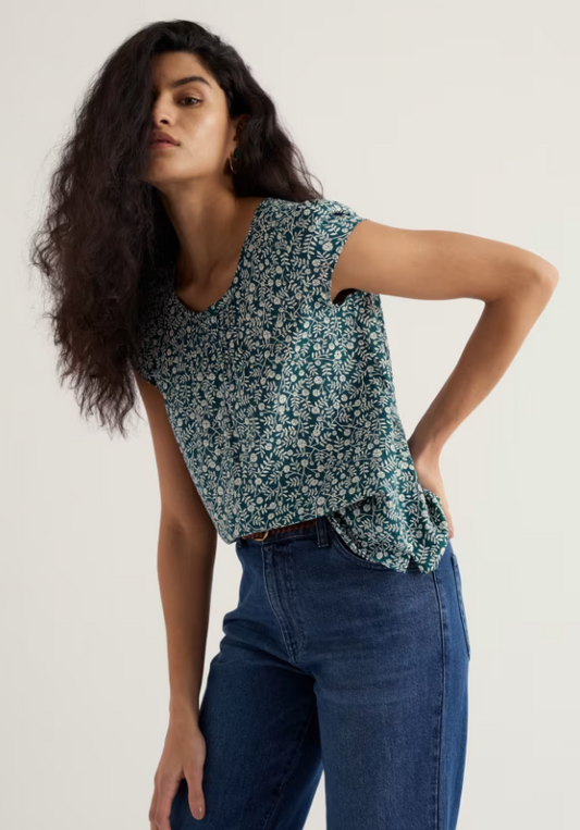 Seasalt Garden Gate Cotton Top Folky Marigolds Dark Wreckage womens summer top Semi fitted with a Scoop neck and Keyhole detail that's Machine Wash 30C Colour: Folky Marigolds Dark Wreckage Material: 100% Organic Cotton Woman wearing a floral top and blue jeans against a plain background