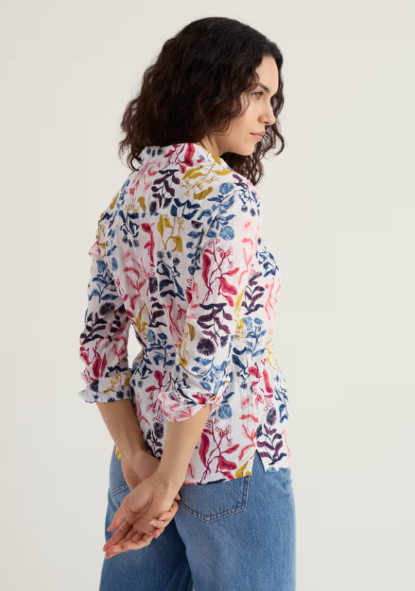 Seasalt Larissa Shirt Inky Botanical Chalk Womens shirt Semi-fitted with a Collared and Roll back cuffs with Button fastening and 100% Organic Cotton Machine Wash 30C. Certified organic to Global Organic Textile Standards (GOTS) by Soil Association Certification DK16784 Colour: Inky Botanical Chalk Woman wearing a colorful floral shirt and blue jeans on a white background