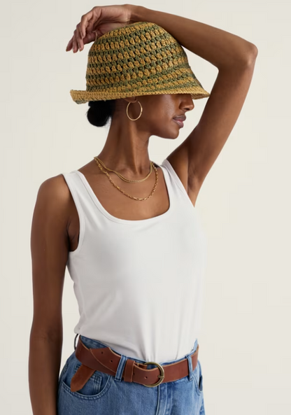 Seasalt Mabe Fitted GOTS-Certified Organic Cotton Rich Vest Salt womens Fitted style with a Square neck that's Machine Washable, Made from 93% Organic Cotton & 7% Elastane. Seasalt's Mabe vest combines comfort with conscience. Crafted from organic cotton-rich fabric, this fitted style offers a clean, versatile layer for everyday wear Woman wearing a white tank top, blue jeans, and a woven hat on a plain background