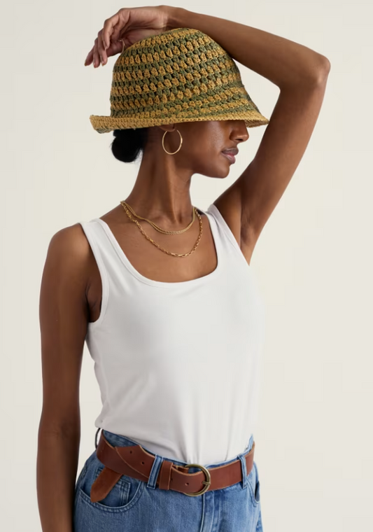 Seasalt Mabe Fitted GOTS-Certified Organic Cotton Rich Vest Salt womens Fitted style with a Square neck that's Machine Washable, Made from 93% Organic Cotton & 7% Elastane. Seasalt's Mabe vest combines comfort with conscience. Crafted from organic cotton-rich fabric, this fitted style offers a clean, versatile layer for everyday wear Woman wearing a white tank top, blue jeans, and a woven hat on a plain background