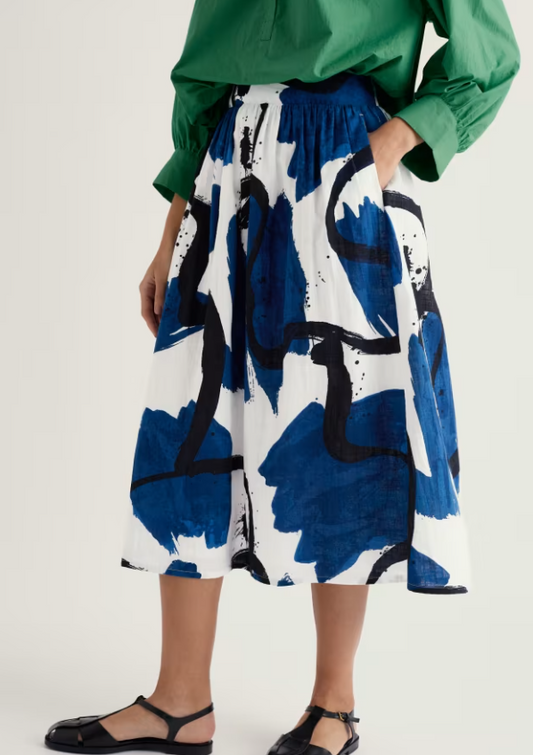 Seasalt Mevagissey Midi Skirt Paint Canvas Dark Voyage womens A-line that's Elasticated back waist with a Wide waist band and In-seam pockets that's Machine Wash 30C Colour: Paint Canvas Dark Voyage Material: 100% Organic Cotton Person wearing a green top and blue and white floral skirt on a plain background