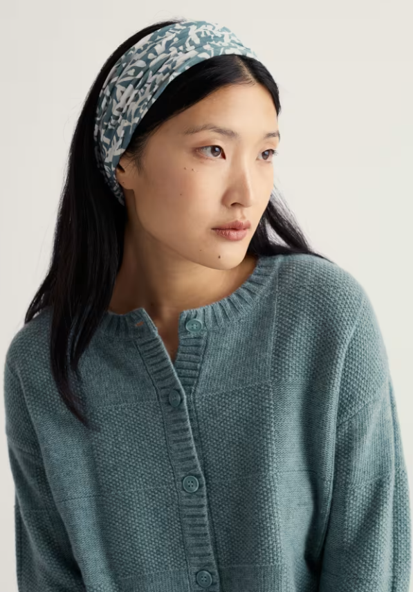 Seasalt Organic Cotton Handyband Blotted Anemone Lichen 2 Handybands for £20 Made from soft, organic cotton Seasalt jersey with a little stretch Woman wearing a teal knitted cardigan and patterned headband against a plain background