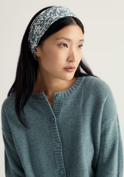 Seasalt Organic Cotton Handyband Blotted Anemone Lichen 2 Handybands for £20 Made from soft, organic cotton Seasalt jersey with a little stretch Woman wearing a teal knitted cardigan and patterned headband against a plain background