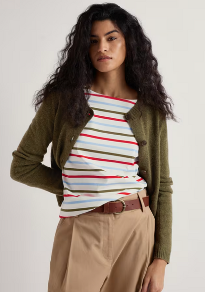 Seasalt Tern Tide Cardigan Seagrass womens Semi fitted with a Crew neck that's Button fastening and Ribbed hem and cuffs with Ribbed neckline that should be Hand Wash In Cold Water Colour: Seagrass Material: 60% Merino Wool & 40% Nylon Woman wearing a striped shirt, green cardigan, and beige pants on a white background