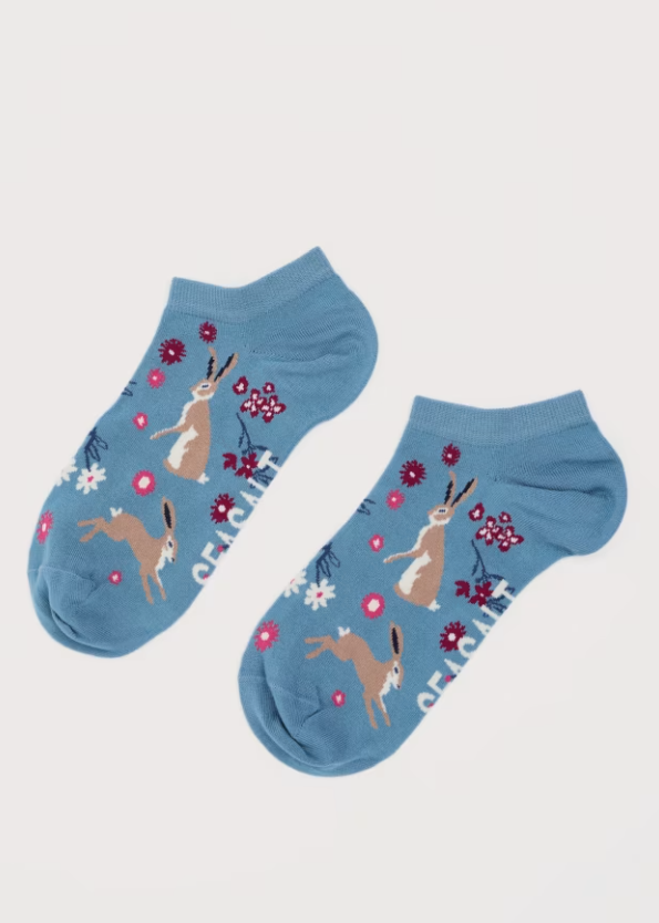 Seasalt Women's Arty Trainer Socks Hares Leap Seascape Lightweight Material: 71% Bamboo (derived viscose), 28% Recycled Polyamide & 1% Elastane trainer socks Pair of blue socks with rabbit and flower pattern on a light gray background