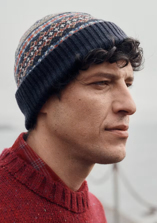 Seasalt Men's Rowan Tree Hat Sparnon Multi Mens Beanie Seasalt clothing Man wearing a patterned knit beanie and red sweater against a neutral background