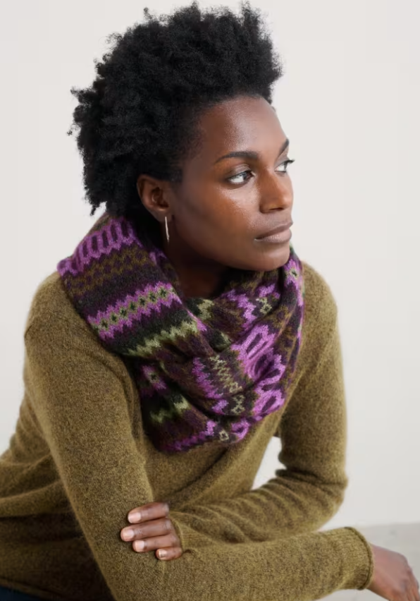 Seasalt Morning Cliff Snood Modernist Grape Oak Mix Seasalt clothing womens snood Woman wearing a brown sweater and a colorful knitted scarf against a white background