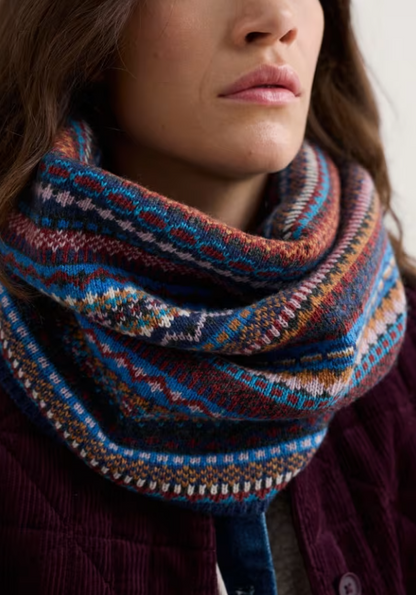 Seasalt Touchstone Snood Star Jasmine Coal Jetty Mix Seasalt clothing womens snood Close-up of a person wearing a colorful patterned scarf.