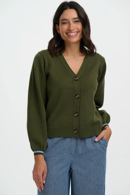 Sugarhill Brighton Adrian Cardigan Khaki Leopard Jungle womens Buttoned front with V-neck and Blouson sleeve that's Machine washable (delicate) Colour: Khaki Leopard Jungle Material: 51% Viscose, 30% Polyester & 19% Nylon Woman wearing an olive green cardigan and blue pants on a white background