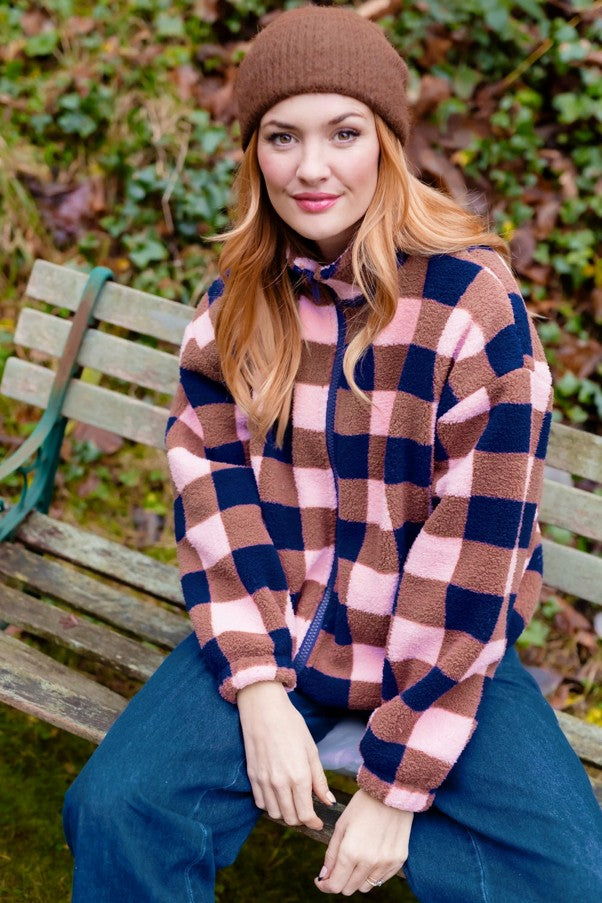 Sugarhill Brighton Hartley Zip Up Fleece Navy/Pink Check. Womens checked fleece with Longer sleeves and Stretch cuffs and Drawstring hem to adjust the fit. Including Pockets with Funnel neck and Zip front that's Machine washable (delicate). Material: 100% Recycled Polyester