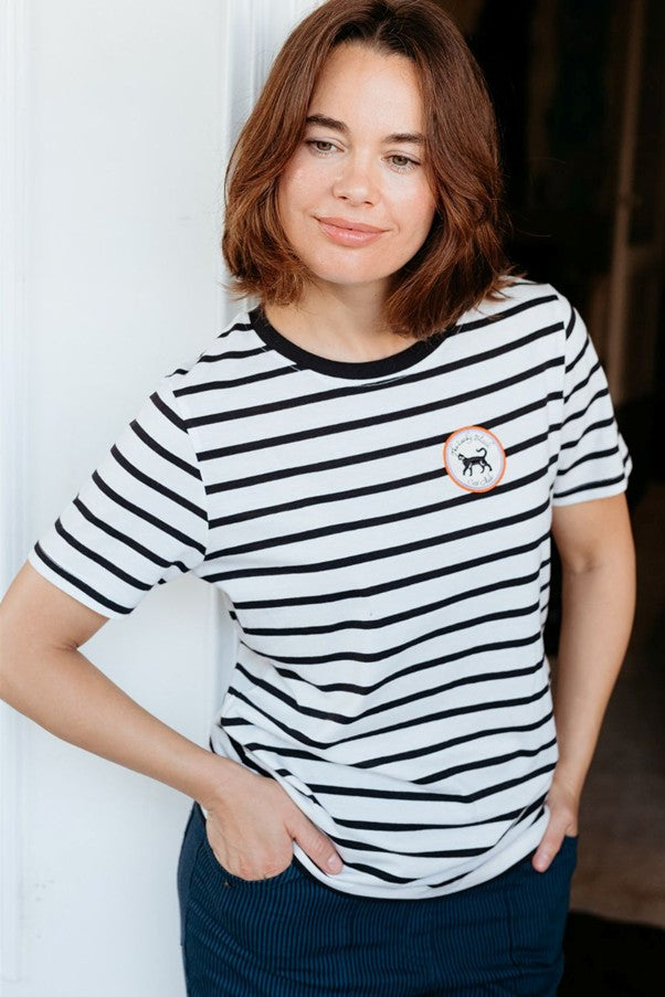 Sugarhill Brighton Maggie T-shirt Off White / Black Lucky Cat womens Signature shape with Crew neck that's Machine washable (delicate) Colour: Off White / Black Lucky Cat Material: 100% Organic Cotton Woman wearing a black and white striped t-shirt with a small logo.