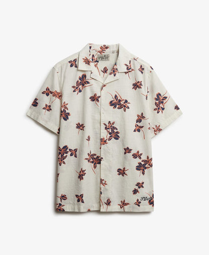 Superdry Cabana Poolside Short Sleeve Shirt Lotus Flower Off White mens Relaxed fit – the classic Superdry fit with Single collar with button fastening and Embroidered text on the hemline Colour: Lotus Flower Off White Material: 100% Organic Cotton Floral patterned shirt on a white background