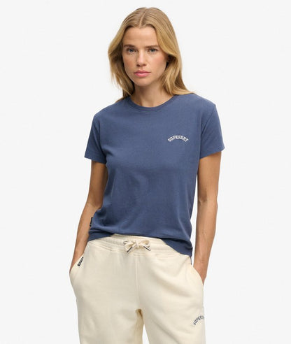 Superdry Essential Logo Fitted T-shirt Mariner Navy womens Slim fit – designed to fit closer to the body for a more tailored look with a Crew ribbed neckline and Embroidered text on chest and Superdry tab on the side Colour: Mariner Navy Material: 100% Organic Cotton Style Code: W1011346C Woman wearing a blue t-shirt with a logo on a white background