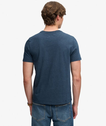 Superdry Mercantile Men's T-Shirt Eclipse Navy. Wit a Relaxed fit Ribbed crew neckline and short sleeves with Distressed trims and Printed graphic across chest Material: 100% Organic Cotton Style Code: M1012434A Colour Code: 98T
