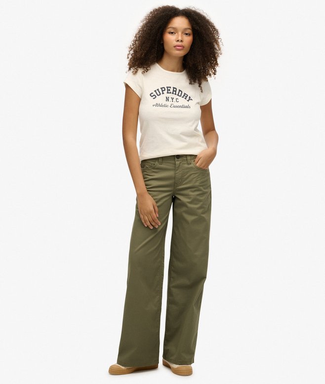 Superdry Mid Rise Baggy Chino Dusty Olive Green Wide womens Fit. Some call it baggy, some call it anti-fit, and others go with relaxed. It’s a cut that’s more generous. From seat right through to ankle, there’s just more room to move+Mid-rise fit with zip and button fastening+Belt loops on the waistband+Five pockets with an embroidered logo on the front Colour: Dusty Olive Green Material: 98% Cotton & 2% Woman wearing a white t-shirt with 'Superdry' logo and green pants on a white background