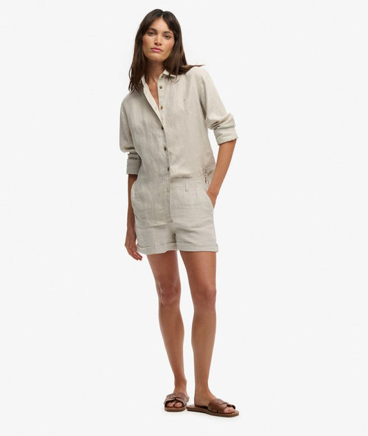 Superdry Mid Rise Linen Shorts Light Stone Beige womens Straight Fit shorts with Button and zip fastening and Belt loops with Four pocket design with Signature metal tab on right pocket Colour: Light Stone Beige Material: 100% Linen Woman wearing a beige linen shirt and shorts on a white background