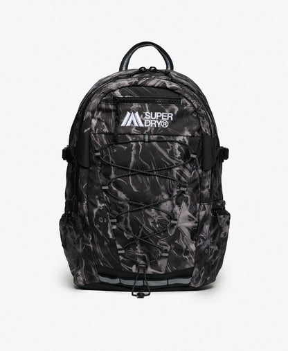 Superdry Outdoor 28L Backpack Woodgrain Print Black featuring Top handle with Main zipped compartment with internal mesh zip pocket and Internal laptop sleeve with hook and loop fastening with Two side pockets and a Padded back panel with Adjustable straps and mbroidered Superdry logo plus Superdry logo badge on strap Colour: Skate Navy Material: Polyester & Nylon Size: H 45.5cm x W 30cm x D 13.5cm