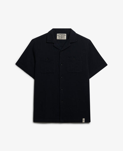 Superdry Textured Short Sleeve Shirt Black mens Relaxed fit with Single collar with button fastening Two chest pockets with button fastening Colour: Black Material: 100% Organic Cotton Style Code: M4011123A Black short-sleeve shirt with a brand label on a white background