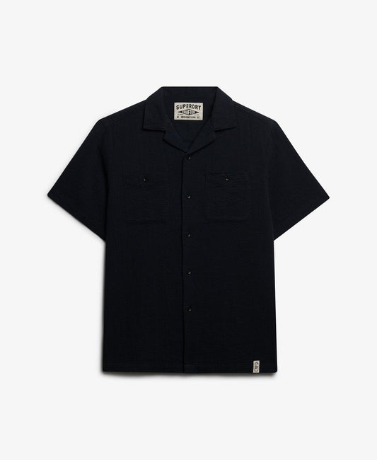 Superdry Textured Short Sleeve Shirt Black mens Relaxed fit with Single collar with button fastening Two chest pockets with button fastening Colour: Black Material: 100% Organic Cotton Style Code: M4011123A Black short-sleeve shirt with a brand label on a white background