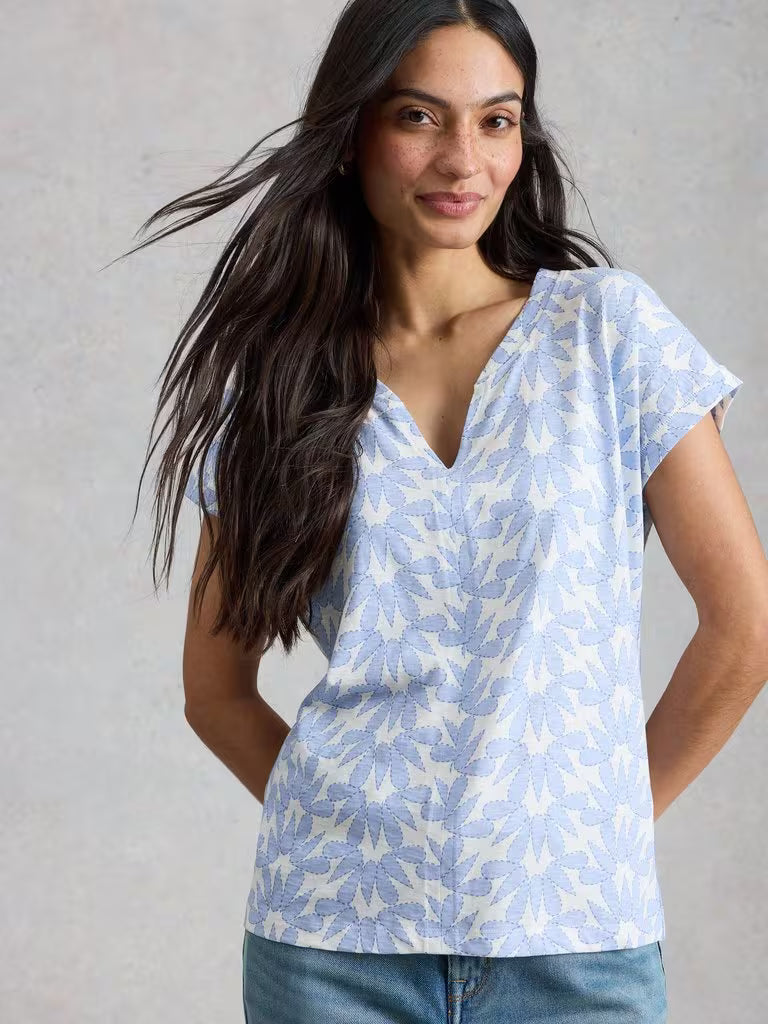White Stuff Nelly Notch Neck Short Sleeve T-shirt Blue Print womens Buy 2 Selected T-Shirts For £45 Notch Neck with Short Sleeve and a Regular Fit that's Machine Washable Colour: Blue Print Material: 100% Cotton Style Code: 445349 Woman wearing a light blue patterned top against a neutral background