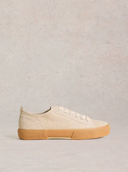 White Stuff Pippa Cord Lace Up Trainer Light Natural womens Pippa trainers have had a revamp. In a textured cord material and lace up style. (Now that's fancy footwork.) Colour: Light Natural Material: Upper: Recycled Cotton, Lining: Cotton, Sole: Rubber Beige sneaker with a brown sole on a light gray background