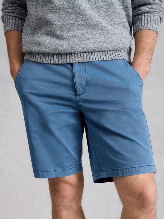 White Stuff Sutton Chino Short Organic Indigo Blue mens Classic Fit that are Knee Length and Machine Washable Colour: Indigo Blue Person wearing blue shorts and a gray sweater on a light gray background