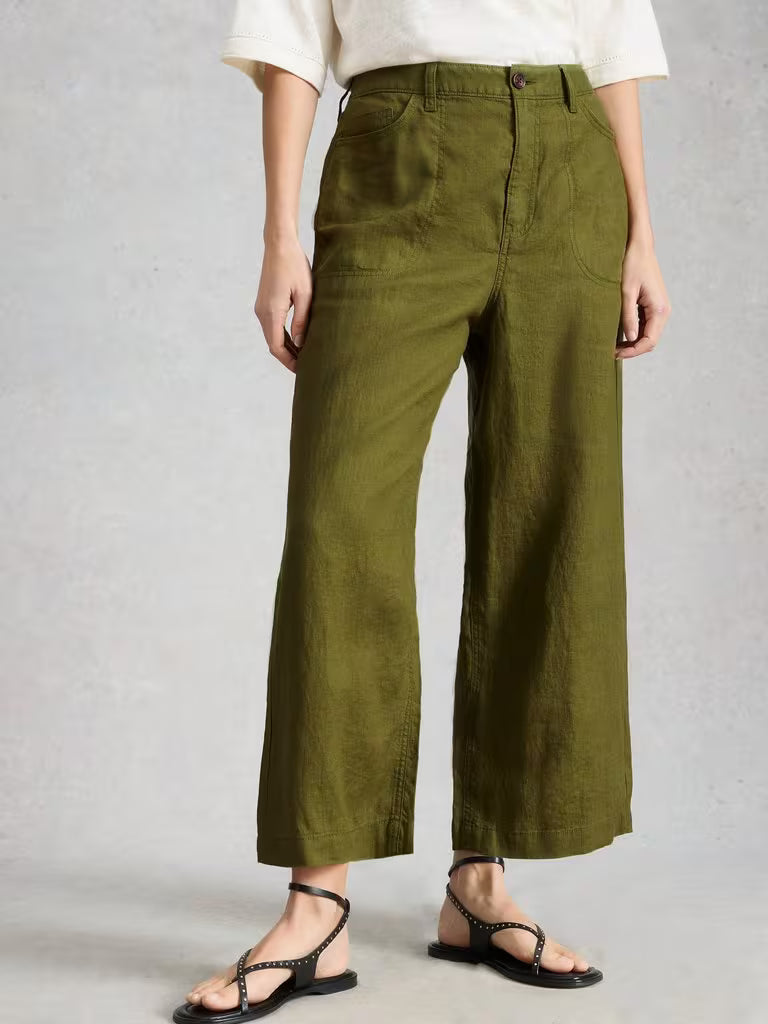 White Stuff Tia Cord Wide Leg Mid Green erson wearing green wide-leg pants on a plain background