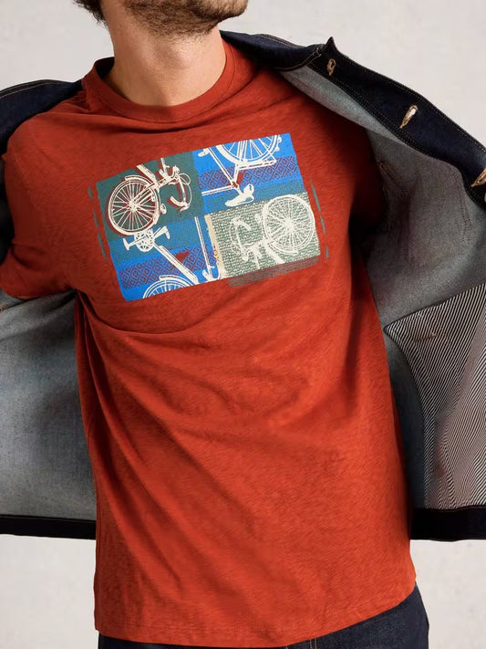 WhiteStuffAbersochGraphicCollageBikeOrange Person wearing a red t-shirt with a graphic design of bicycles on a plain background