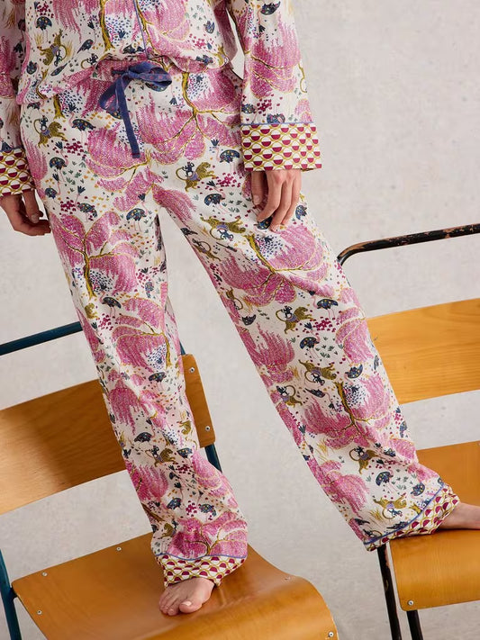 White Stuff Organic Nina PJ Bottom Natural White Stuff Clothing womens pyjama bottoms  Person wearing a colorful floral pajama set sitting on a chair.